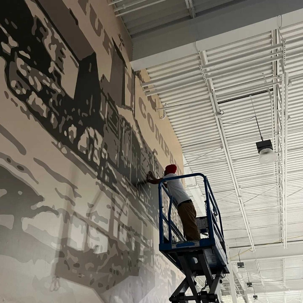 Commercial wall graphic installation from lift equipment