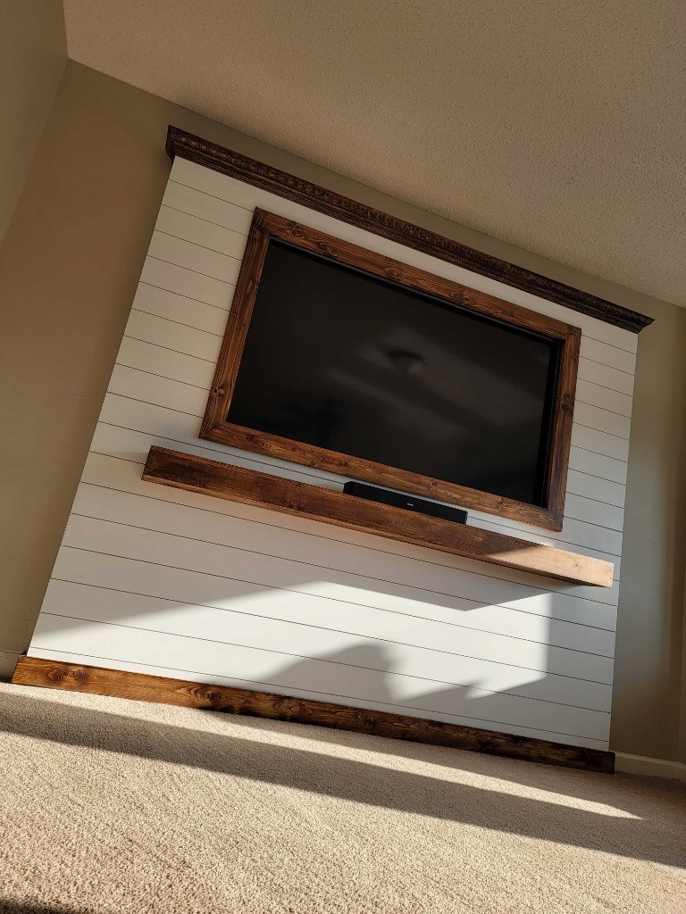 Custom shiplap TV feature wall with wood trim