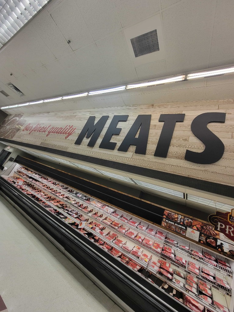 Retail meat department signage installation